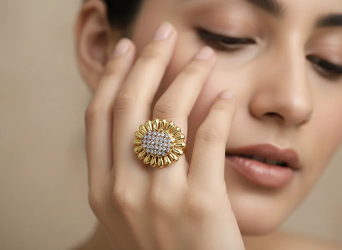 Gold-plated ring with a ruby centre stone and pavé halo